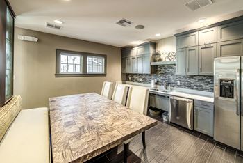 A kitchen with stainless steel appliances and a wooden table